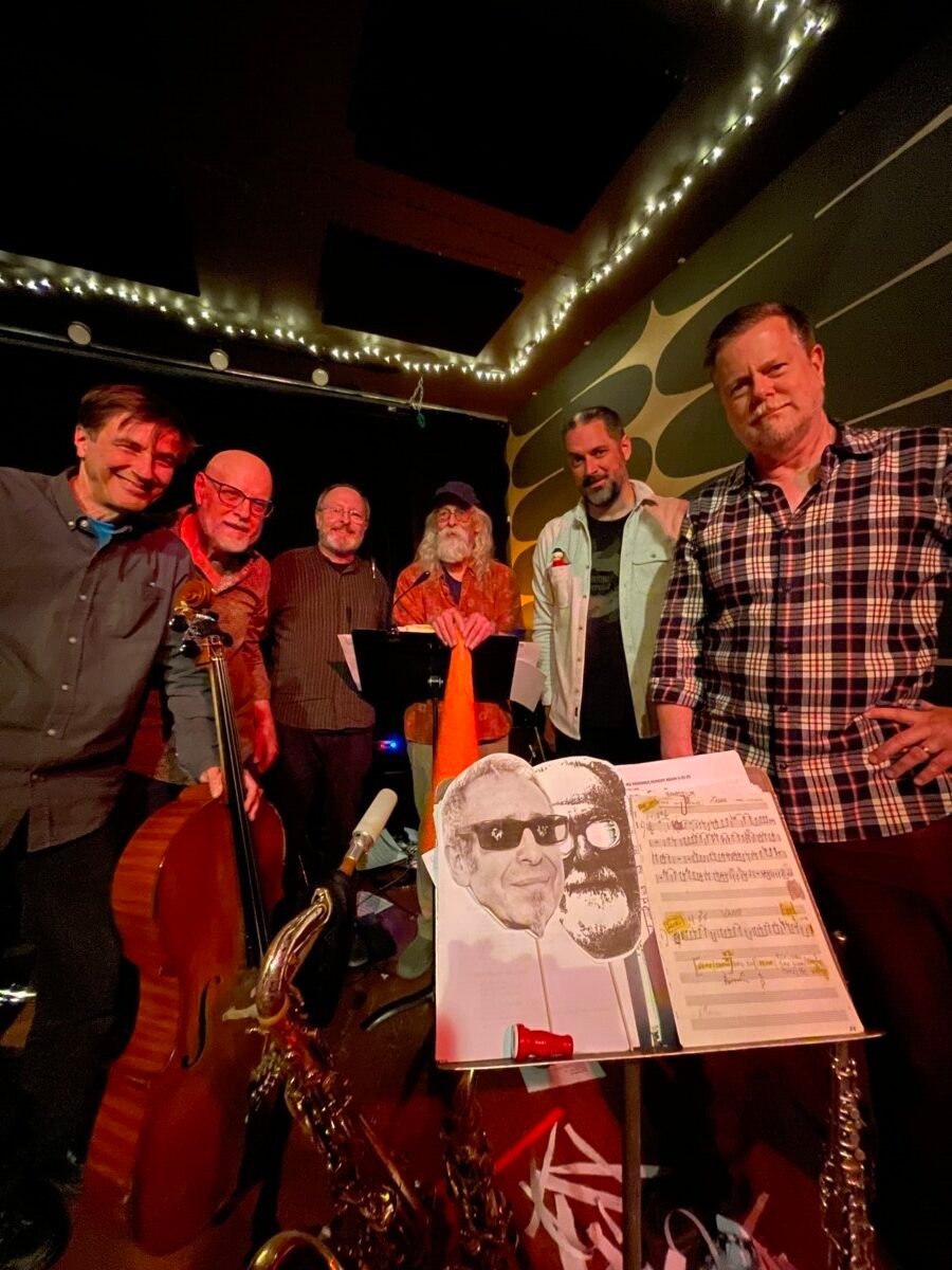 NRG Ensemble photo by John Corbett (left to right: Fred Lonberg-Holm, Kent Kessler, Steve Hunt, Brian Sandstrom, Dave Rempis, Ken Vandermark)
